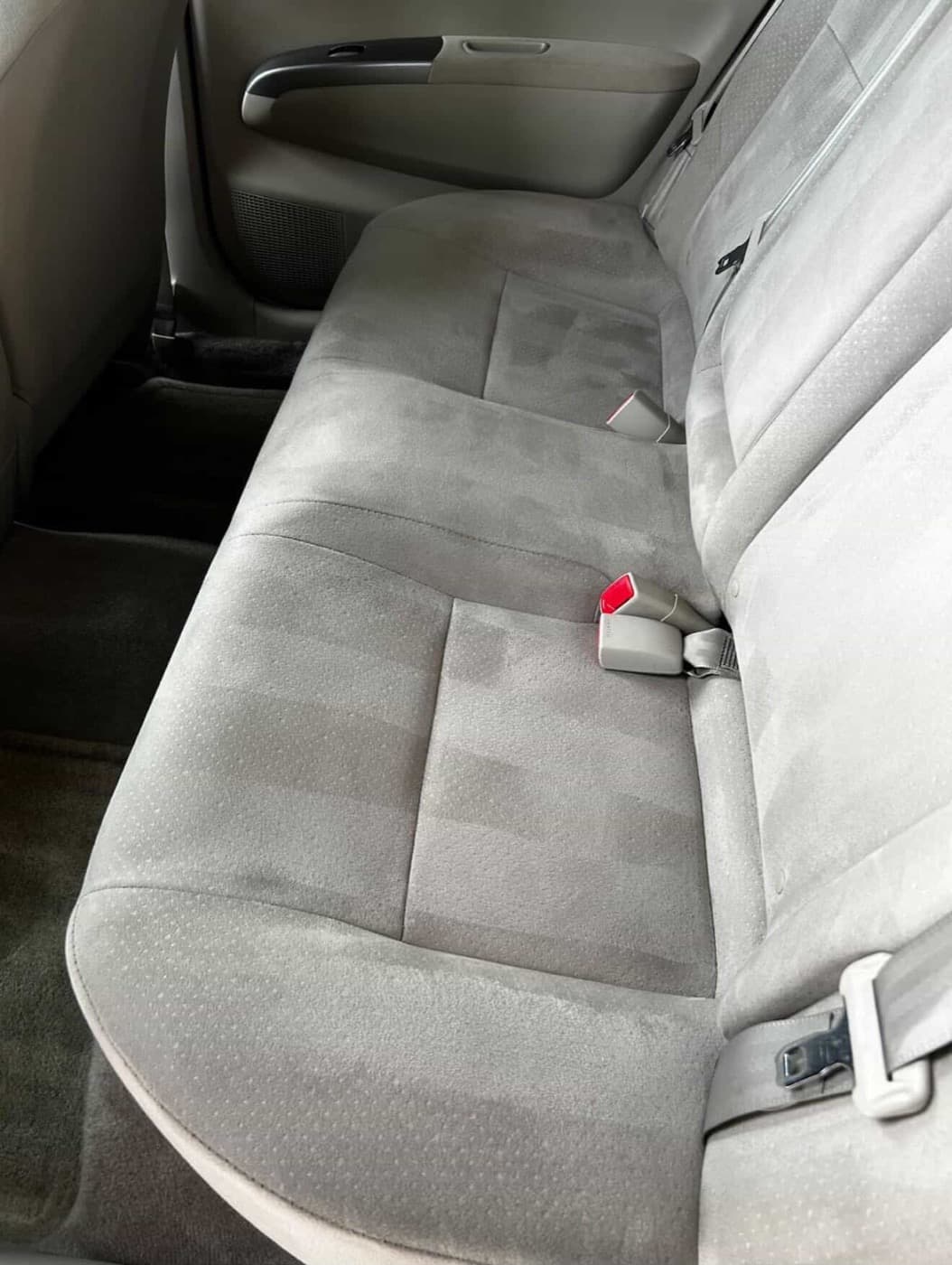 Car rear seat after detailing — clean gray fabric