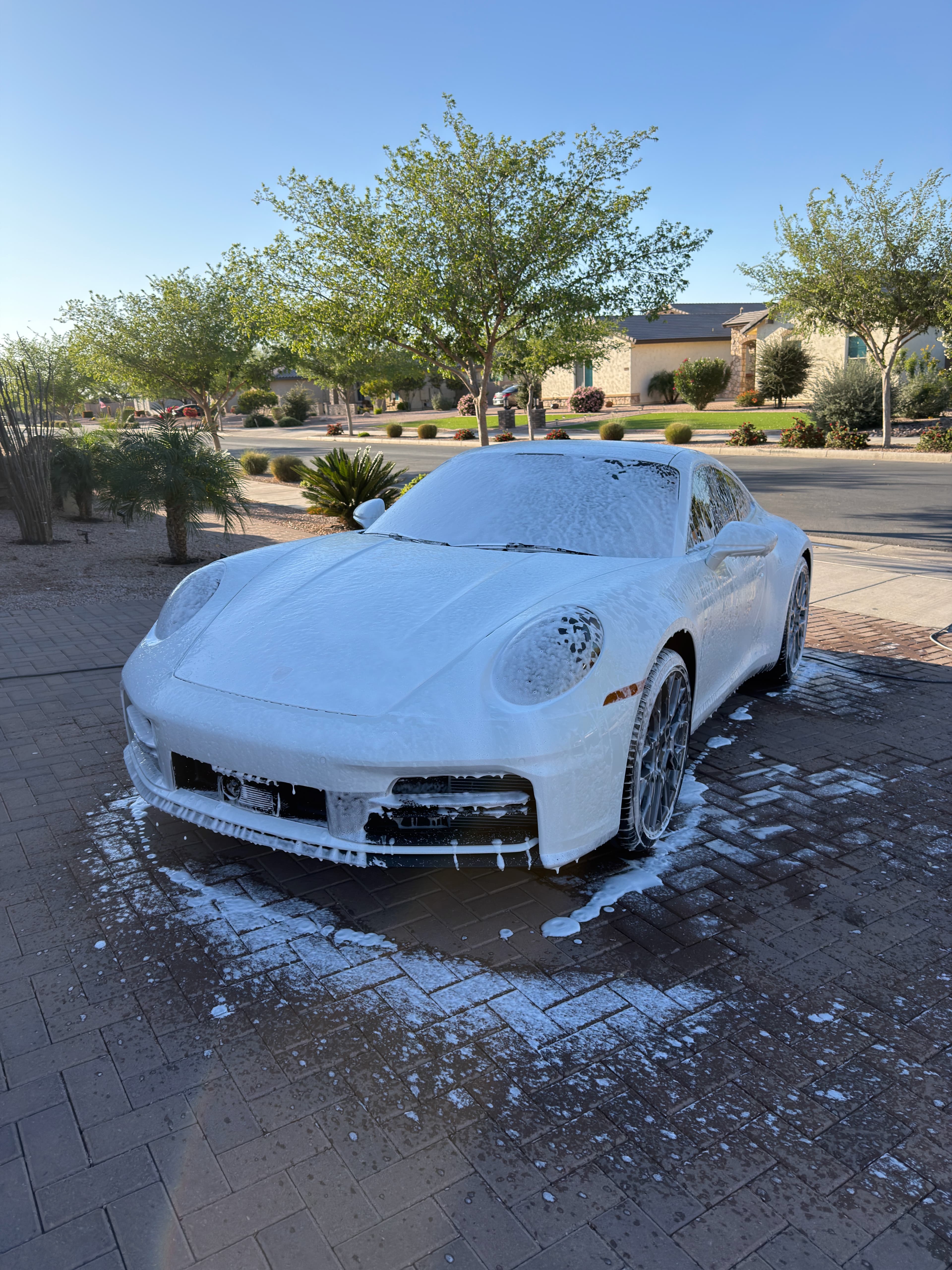 White Porsche covered in foam during exterior wash — mobile car detailing Tucson AZ